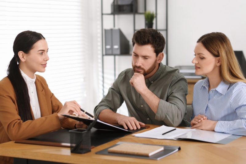 Couple Looking Over Paper Document.